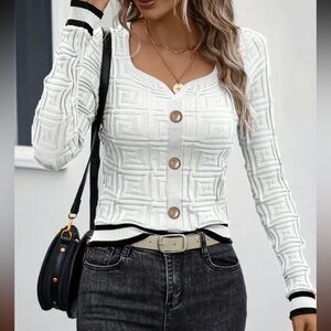 NWT Unbranded white imprinted sweater with black striped trim, Sz. XL.